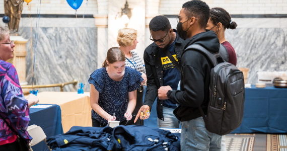 Photo of students handing out giveaway items at the 2022 Drexel Welcome & Resource Fair.